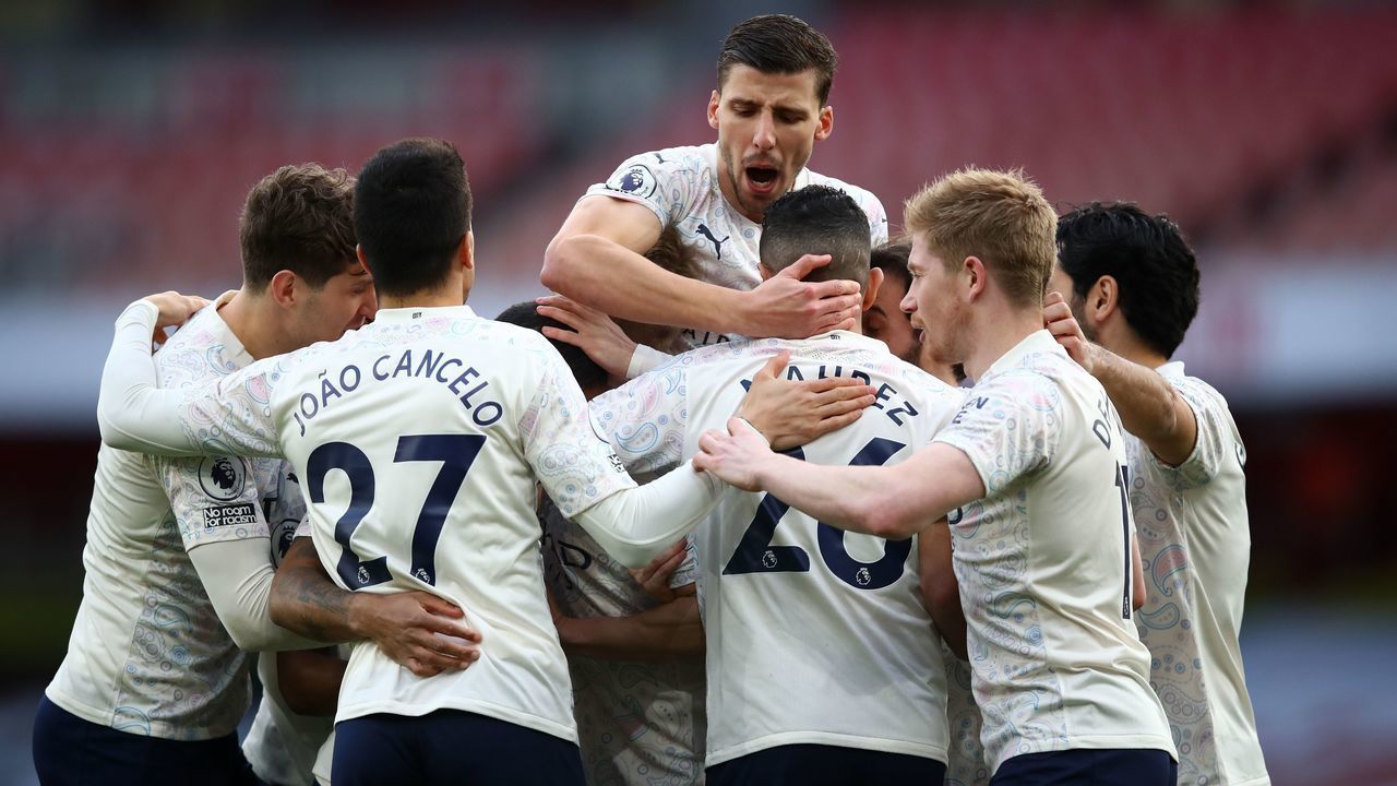 Manchester City's English midfielder Raheem Sterling celebrates with teammates after scoring the opening goal of the English Premier League football match between Arsenal and Manchester City at the Emirates Stadium in London on February 21, 2021.