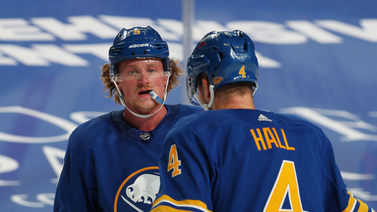 BUFFALO, NY - JANUARY 14: Jack Eichel #9 of the Buffalo Sabres talks to Taylor Hall #4 during an NHL game against the Washington Capitals on January 14, 2021 at KeyBank Center in Buffalo, New York.