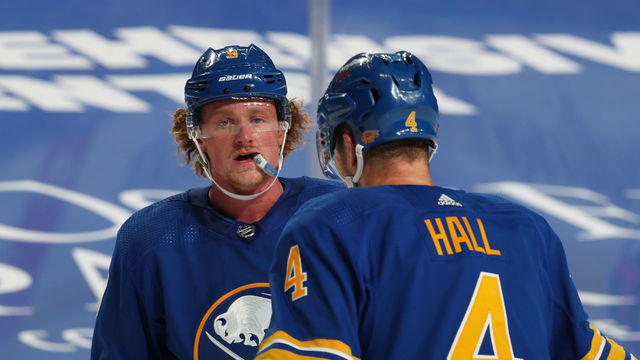 BUFFALO, NY - JANUARY 14: Jack Eichel #9 of the Buffalo Sabres talks to Taylor Hall #4 during an NHL game against the Washington Capitals on January 14, 2021 at KeyBank Center in Buffalo, New York.