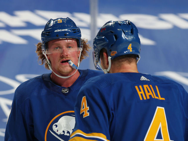 BUFFALO, NY - JANUARY 14: Jack Eichel #9 of the Buffalo Sabres talks to Taylor Hall #4 during an NHL game against the Washington Capitals on January 14, 2021 at KeyBank Center in Buffalo, New York.