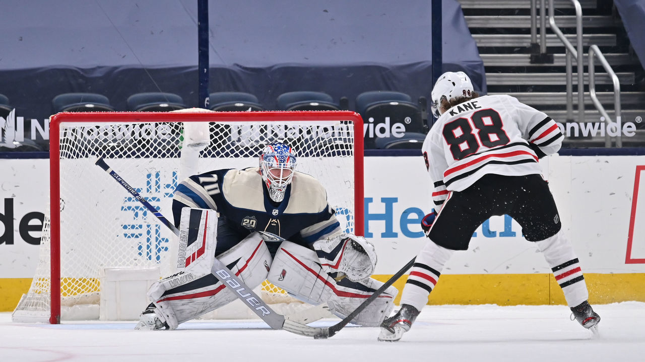 COLUMBUS, OH - FEBRUARY 23: Goaltender Joonas Korpisalo #70 of the Columbus Blue Jackets defends the net as Patrick Kane #88 of the Chicago Blackhawks skates with the puck during a shootout in a game on February 23, 2021 at Nationwide Arena in Columbus, Ohio.