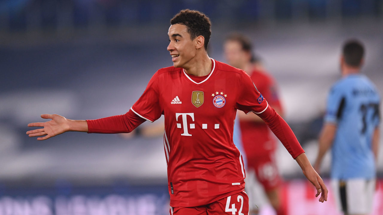ROME, ITALY - FEBRUARY 23: Jamal Musiala of FC Bayern Muenchen celebrates after scoring their side's second goal during the UEFA Champions League Round of 16 match between Lazio Roma and Bayern München at Olimpico Stadium on February 23, 2021 in Rome, Italy. Sporting stadiums around Italy remain under strict restrictions due to the Coronavirus Pandemic as Government social distancing laws prohibit fans inside venues resulting in games being played behind closed doors.