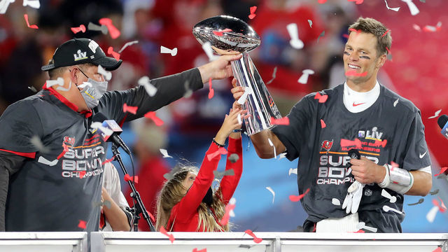 TAMPA, FL - FEBRUARY 07: Super Bowl MVP Tom Brady (12) of the Buccaneers accepts the Lombardi Trophy from General Manager Jason Licht after the Super Bowl LV game between the Kansas City Chiefs and the Tampa Bay Buccaneers on February 7, 2021 at Raymond James Stadium, in Tampa, FL.