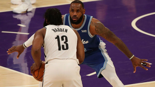 LOS ANGELES, CALIFORNIA - FEBRUARY 18: LeBron James #23 of the Los Angeles Lakers guards James Harden #13 of the Brooklyn Nets during the first quarter at Staples Center on February 18, 2021 in Los Angeles, California.