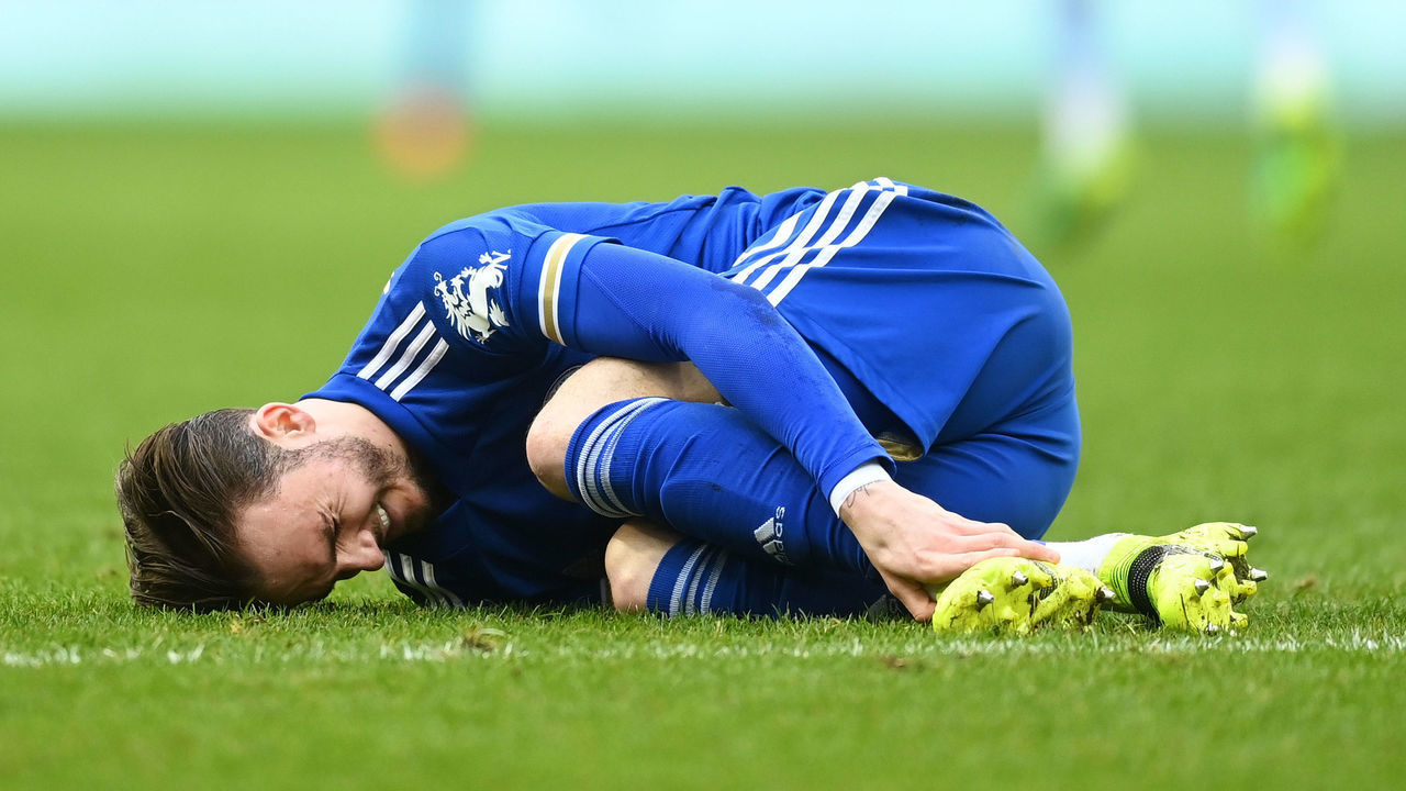 BIRMINGHAM, ENGLAND - FEBRUARY 21: James Maddison of Leicester City goes down injured during the Premier League match between Aston Villa and Leicester City at Villa Park on February 21, 2021 in Birmingham, England. Sporting stadiums around the UK remain under strict restrictions due to the Coronavirus Pandemic as Government social distancing laws prohibit fans inside venues resulting in games being played behind closed doors.