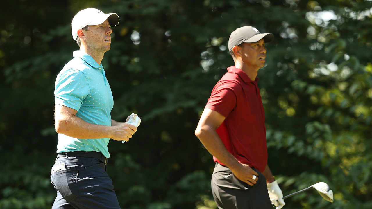 NORTON, MASSACHUSETTS - AUGUST 23: (L-R) Rory McIlroy of Northern Ireland and Tiger Woods of the United States look on from the ninth tee during the final round of The Northern Trust at TPC Boston on August 23, 2020 in Norton, Massachusetts.