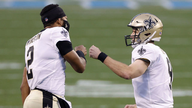 CHARLOTTE, NORTH CAROLINA - JANUARY 03: Quarterback Drew Brees #9 of the New Orleans Saints celebrates with teammate quarterback Jameis Winston #2 following a touchdown pass during the first quarter of their game against the Carolina Panthers at Bank of America Stadium on January 03, 2021 in Charlotte, North Carolina.