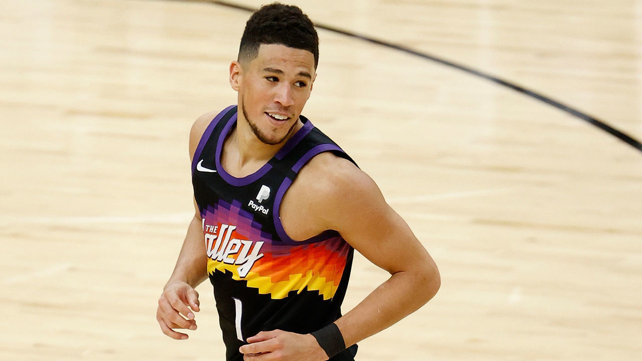 PHOENIX, ARIZONA - FEBRUARY 13: Devin Booker #1 of the Phoenix Suns reacts after a three-point shot against the Philadelphia 76ers during the second half of the NBA game at Phoenix Suns Arena on February 13, 2021 in Phoenix, Arizona. The Suns defeated the 76ers 120-111.