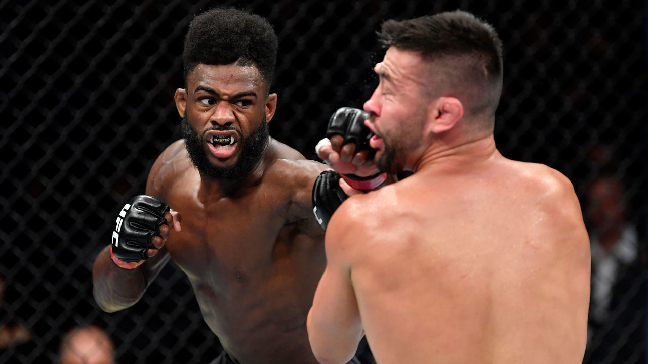 CHICAGO, IL - JUNE 08: (L-R) Aljamain Sterling punches Pedro Munhoz of Brazil in their bantamweight bout during the UFC 238 event at the United Center on June 8, 2019 in Chicago, Illinois.