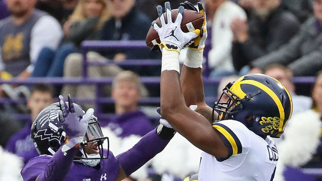 EVANSTON, IL - SEPTEMBER 29: Nico Collins #4 of the Michigan Wolverines tries to catch a pass over JR Pace #13 of the Northwestern Wildcats at Ryan Field on September 29, 2018 in Evanston, Illinois.