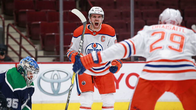 VANCOUVER, BC - FEBRUARY 23: Edmonton Oilers Center Connor McDavid (97) celebrates scoring a goal on Vancouver Canucks Goalie Thatcher Demko (35) after a pass from Oilers Left Wing Leon Draisaitl (29) during their NHL game at Rogers Arena on February 23, 2021 in Vancouver, British Columbia, Canada.