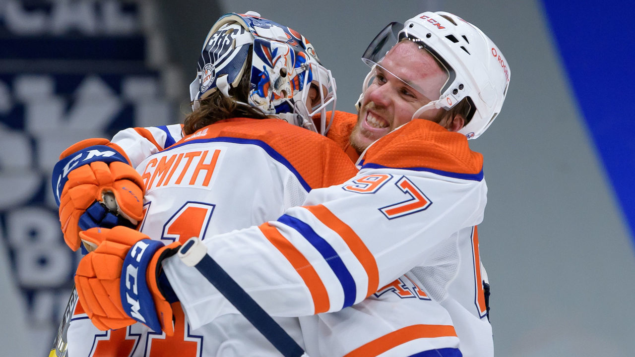 VANCOUVER, BC - FEBRUARY 25: Edmonton Oilers goaltender Mike Smith (41) and center Connor McDavid (97) celebrate a win after during their NHL game against the Vancouver Canucks at Rogers Arena on February 25, 2021 in Vancouver, British Columbia, Canada.