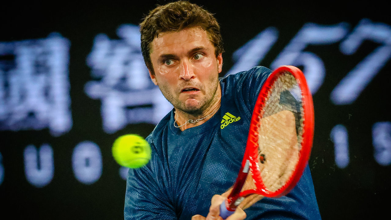 French Gilles Simon plays a backhand during a tennis match between French Simon and Greek Tsitsipas, in the first round of the men's singles competition of the 'Australian Open' tennis Grand Slam, Tuesday 09 February 2021 in Melbourne Park, Melbourne, Australia. The 2021 edition of the Australian Grand Slam has been delayed by three weeks because of the pandemic. BELGA PHOTO PATRICK HAMILTON