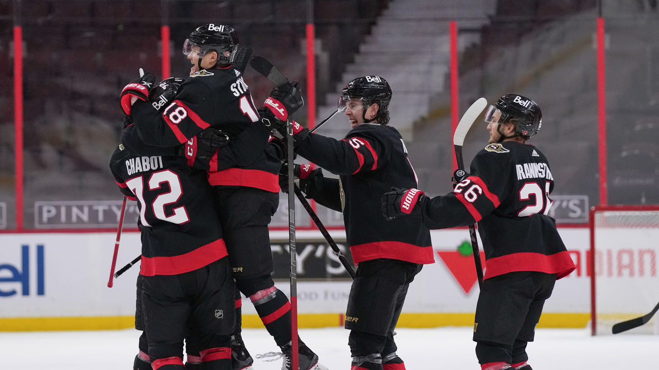 OTTAWA, ON - FEBRUARY 23: Tim Stützle #18 jumps into the arms of Thomas Chabot #72 of the Ottawa Senators to celebrate a shootout win against the Montreal Canadiens at Canadian Tire Centre on February 23, 2021 in Ottawa, Ontario, Canada.