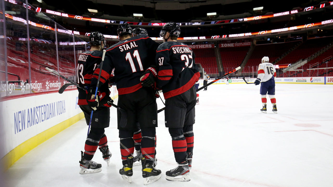 RALEIGH, NC - FEBRUARY 17: Jordan Staal #11 of the Carolina Hurricanes scores a goal and celebrates with teammates Andrei Svechnikov #37 and Warren Foegele #13 during an NHL game against the Florida Panthers on February 17, 2021 at PNC Arena in Raleigh, North Carolina.
