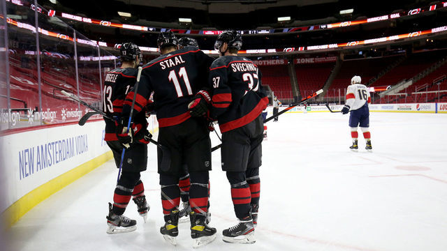 RALEIGH, NC - FEBRUARY 17: Jordan Staal #11 of the Carolina Hurricanes scores a goal and celebrates with teammates Andrei Svechnikov #37 and Warren Foegele #13 during an NHL game against the Florida Panthers on February 17, 2021 at PNC Arena in Raleigh, North Carolina.