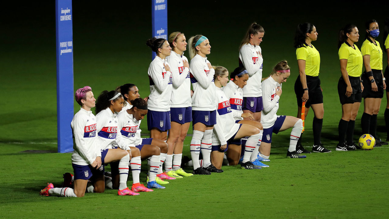 ORLANDO, FL - FEBRUARY 18: United States players kneel for the American national anthem during the SheBelieves Cup at Exploria Stadium on February 18, 2021 in Orlando, Florida.