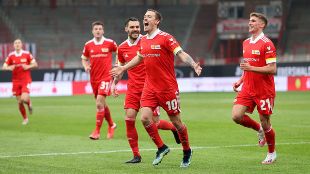 BERLIN, GERMANY - FEBRUARY 28: Max Kruse of 1.FC Union Berlin celebrates with teammates Christopher Trimmel (L) and Grischa Proemel (R) after scoring their team's first goal during the Bundesliga match between 1. FC Union Berlin and TSG Hoffenheim at Stadion An der Alten Foersterei on February 28, 2021 in Berlin, Germany. Sporting stadiums around Germany remain under strict restrictions due to the Coronavirus Pandemic as Government social distancing laws prohibit fans inside venues resulting in games being played behind closed doors.