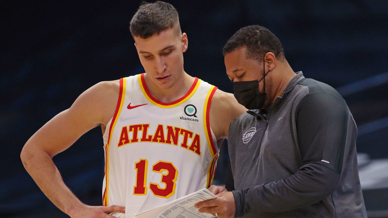 CHARLOTTE, NC - JANUARY 9: Bogdan Bogdanovic #13 talks with Assistant Coach, Melvin Hunt during the game against the Charlotte Hornets on January 9, 2021 at Spectrum Center in Charlotte, North Carolina. Mandatory Copyright Notice: Copyright 2021 NBAE