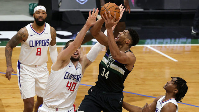 MILWAUKEE, WISCONSIN - FEBRUARY 28: Giannis Antetokounmpo #34 of the Milwaukee Bucks drives to the basket against Ivica Zubac #40 of the LA Clippers during the second half of a game at Fiserv Forum on February 28, 2021 in Milwaukee, Wisconsin.