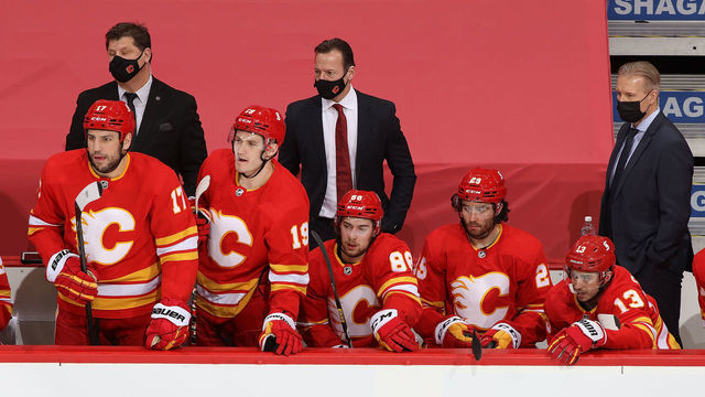 CALGARY, AB - FEBRUARY 9: Milan Lucic #17 and Matthew Tkachuk #19 of the Calgary Flames stand at the bench against the Winnipeg Jets at Scotiabank Saddledome on February 9, 2021 in Calgary, Alberta, Canada.