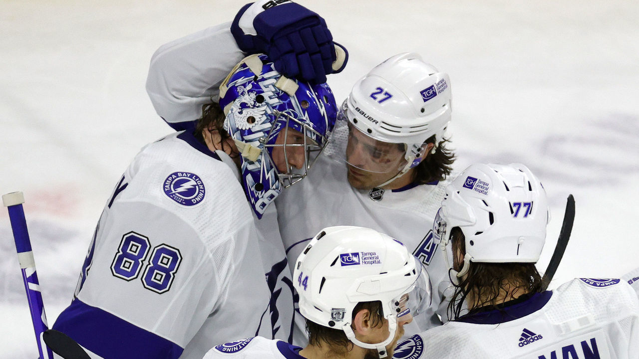 RALEIGH, NORTH CAROLINA - FEBRUARY 22: Andrei Vasilevskiy #88 of the Tampa Bay Lightning celebrates with Ryan McDonagh #27, Jan Rutta #44, and Victor Hedman #77 following their 4-2 win over the Carolina Hurricanes at PNC Arena on February 22, 2021 in Raleigh, North Carolina.