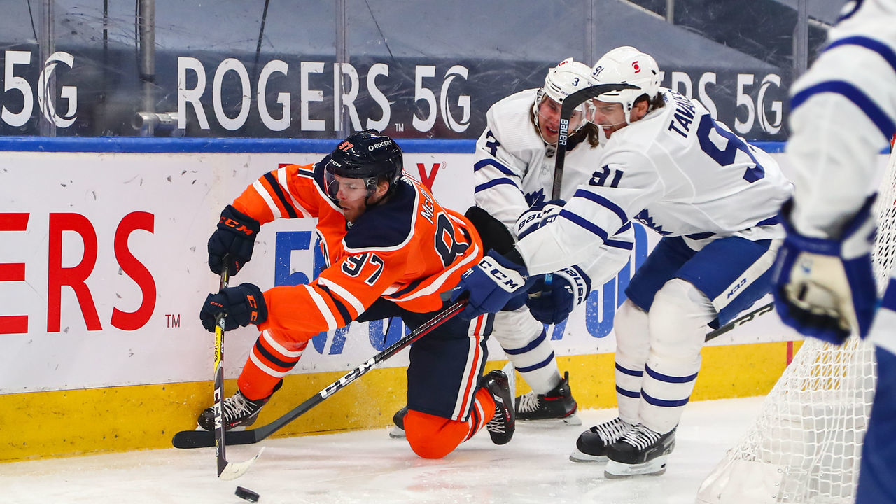 EDMONTON, AB - MARCH 1: Edmonton Oilers Center Connor McDavid (97) makes a pass from his knees in the third period during the Edmonton Oilers game versus the Toronto Maple Leafs on March 1, 2021 at Rogers Place in Edmonton, AB.