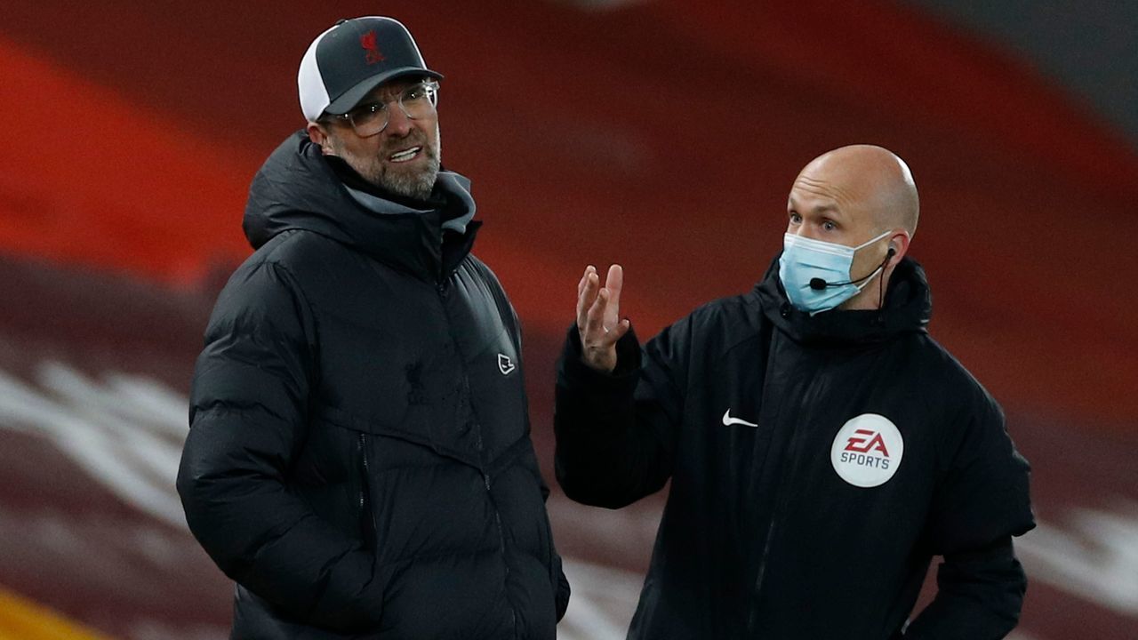 Liverpool's German manager Jurgen Klopp (L) reacts as he talks with the fourth official during the English Premier League football match between Liverpool and Chelsea at Anfield in Liverpool, north west England on March 4, 2021.