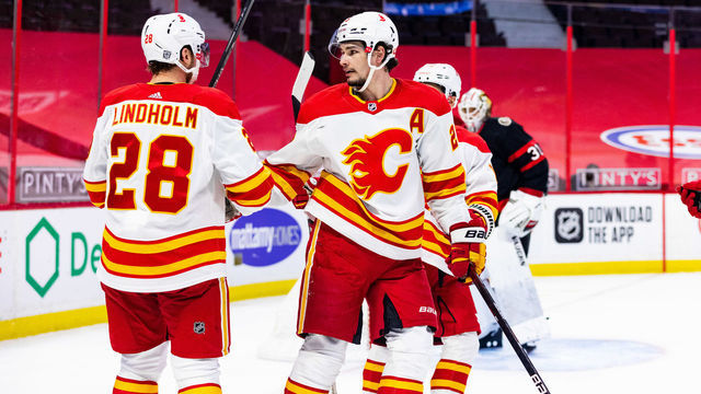 OTTAWA, ON - FEBRUARY 27: Calgary Flames Center Sean Monahan (23) congratulates Calgary Flames Center Elias Lindholm (28) on his goal during first period National Hockey League action between the Calgary Flames and Ottawa Senators on February 27, 2021, at Canadian Tire Centre in Ottawa, ON, Canada.