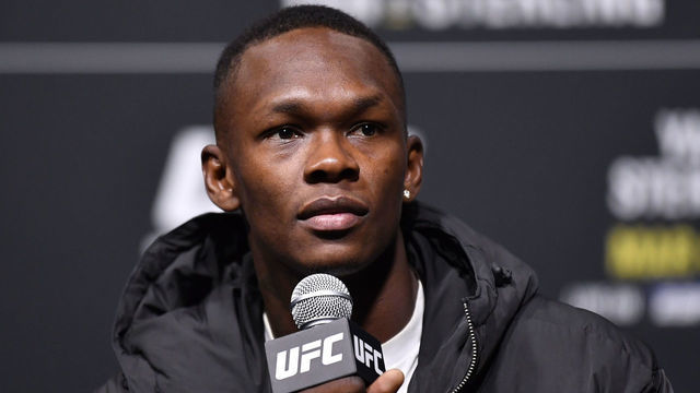LAS VEGAS, NEVADA - MARCH 04: Israel Adesanya of Nigeria interacts with media during the UFC 259 press conference at UFC APEX on March 04, 2021 in Las Vegas, Nevada.