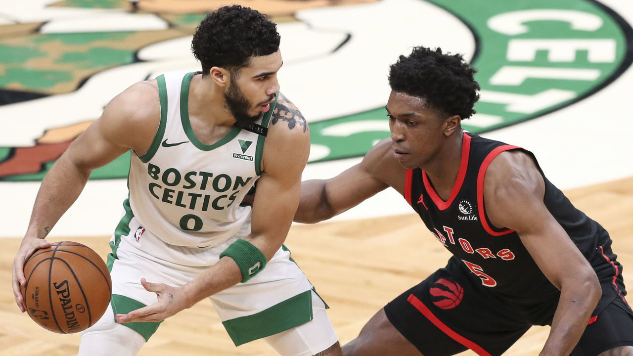 BOSTON, MA - MARCH 04: Jayson Tatum #0 of the Boston Celtics is guarded by Stanley Johnson #5 of the Toronto Raptors at TD Garden on March 4, 2021 in Boston, Massachusetts.