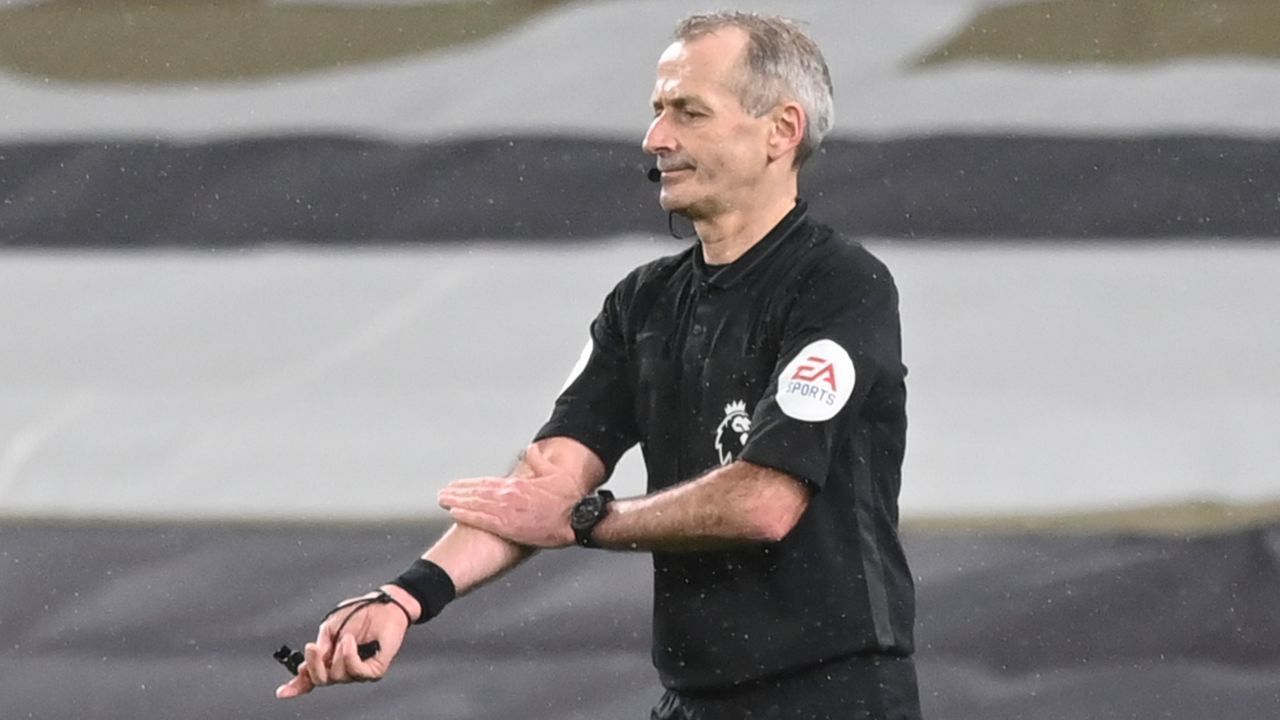 Referee Martin Atkinson gestures to rule out a goal from Liverpool's Egyptian midfielder Mohamed Salah due to a handball earlier in the move during the English Premier League football match between Tottenham Hotspur and Liverpool at Tottenham Hotspur Stadium in London, on January 28, 2021.