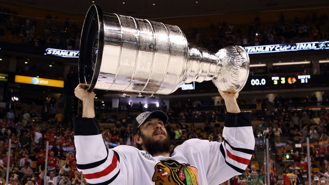 BOSTON, MA - JUNE 24: Brent Seabrook #7 of the Chicago Blackhawks hoists the Stanley Cup Trophy after defeating the Boston Bruins in Game Six of the 2013 NHL Stanley Cup Final at TD Garden on June 24, 2013 in Boston, Massachusetts. The Chicago Blackhawks defeated the Boston Bruins 3-2.