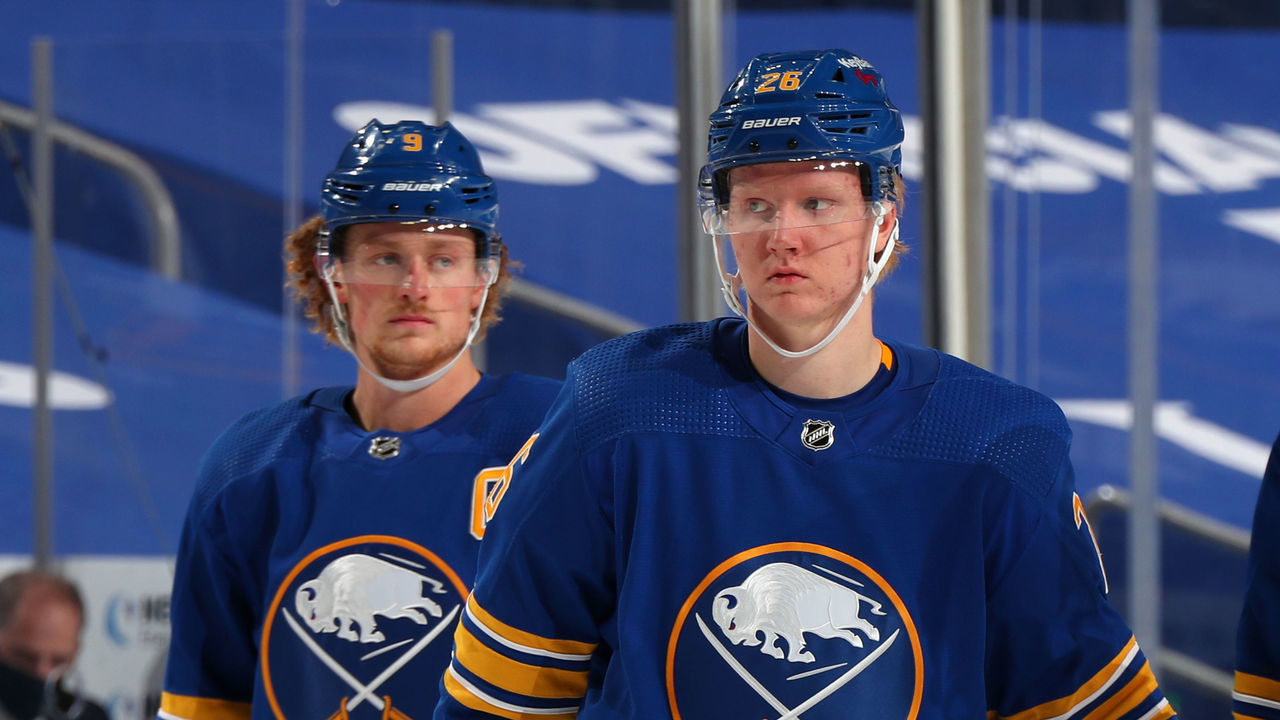 BUFFALO, NY - JANUARY 15: Jack Eichel #9, Rasmus Dahlin #26 and Sam Reinhart #23 of the Buffalo Sabres talk during an NHL game against the Washington Capitals on January 15, 2021 at KeyBank Center in Buffalo, New York.