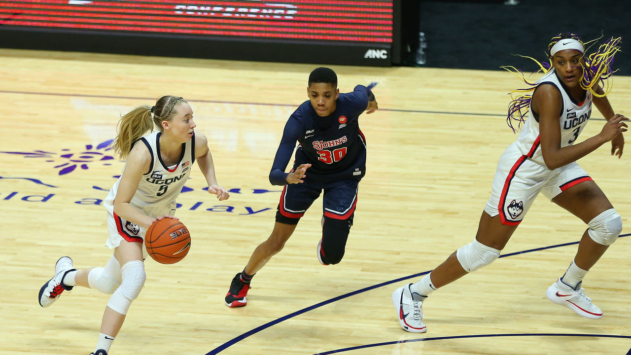 UNCASVILLE, CT - MARCH 06: UConn Huskies guard Paige Bueckers (5) pursued by St. John's Red Storm guard Kadaja Bailey (30) during the women's Big East Conference Tournament between St Johns Red Storm and UConn Huskies on March 6, 2021, at Mohegan Sun Arena in Uncasville, CT.