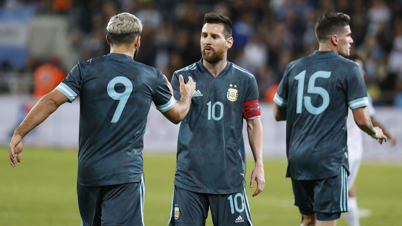 Argentina's forward Sergio Aguero greets Argentina's forward Lionel Messi during the friendly football match between Argentina and Uruguay at the Bloomfield stadium in the Israeli coastal city of Tel Aviv on November 18, 2019.
