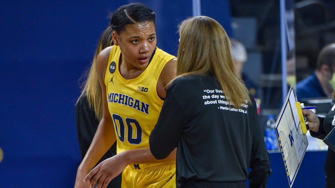 ANN ARBOR, MICHIGAN - FEBRUARY 16: Naz Hillmon #00 of the Michigan Wolverines talks with Head Coach Kim Barnes Arico during the first half of a college basketball game against the Michigan State Spartans at Crisler Arena on February 16, 2021 in Ann Arbor, Michigan.