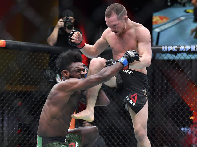 LAS VEGAS, NEVADA - MARCH 06: (R-L) Petr Yan of Russia delivers an illegal knee against Aljamain Sterling in their UFC bantamweight championship fight during the UFC 259 event at UFC APEX on March 06, 2021 in Las Vegas, Nevada.