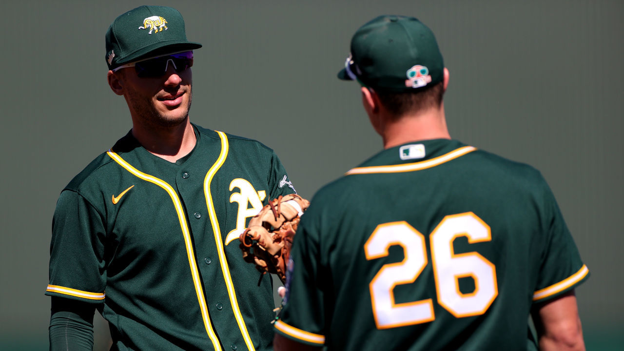 MESA, ARIZONA - MARCH 01: Matt Olson #28 of the Oakland Athletics speaks with Matt Chapman #26 during a preseason game against the Cincinnati Reds at Hohokam Stadium on March 01, 2021 in Mesa, Arizona.