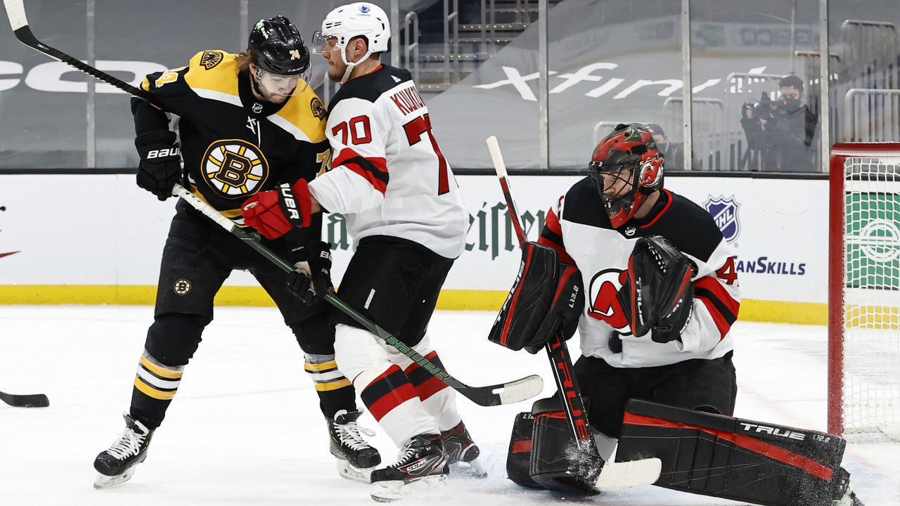 BOSTON, MA - MARCH 07: New Jersey Devils goalie Scott Wedgewood (41) stops the shot in the stomach during a game between the Boston Bruins and the New Jersey Devils on March 7, 2021, at TD Garden in Boston, Massachusetts.
