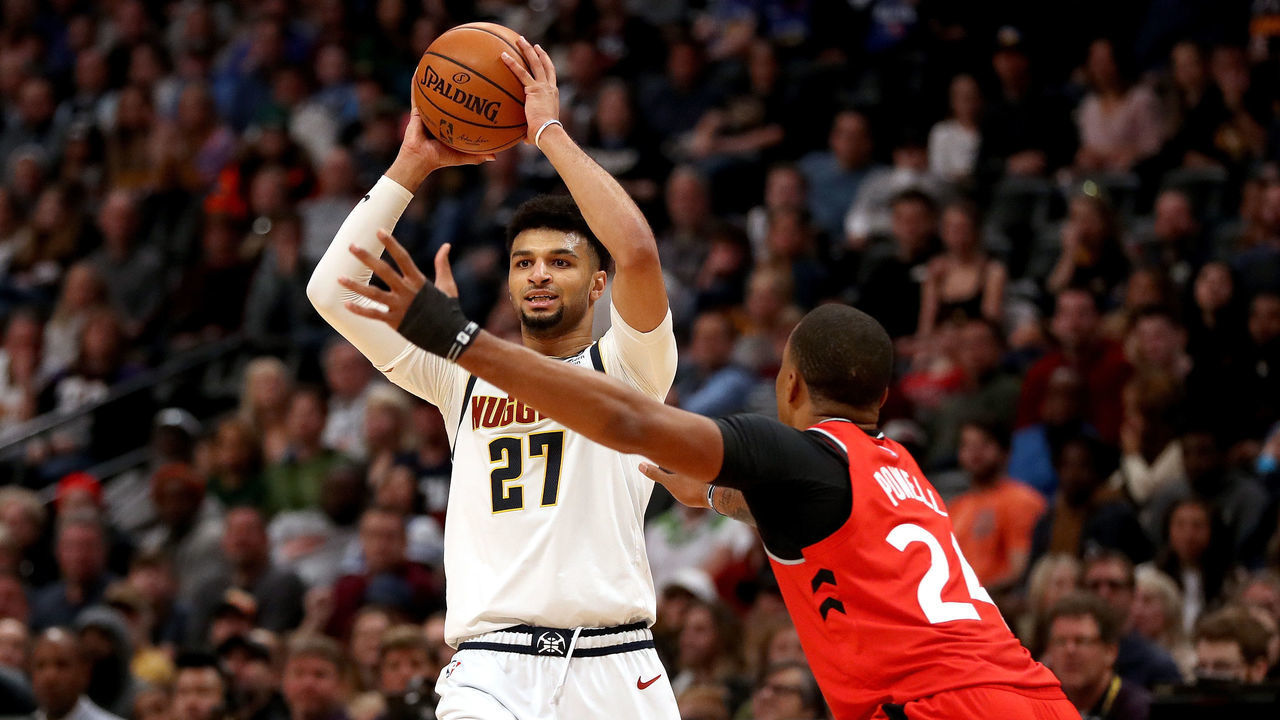 DENVER, COLORADO - MARCH 01: Jamal Murray #27 of the Denver Nuggets is guarded by Norman Powell #24 of the Toronto Raptors in the fourth quarter at the Pepsi Center on March 01, 2020 in Denver, Colorado. (