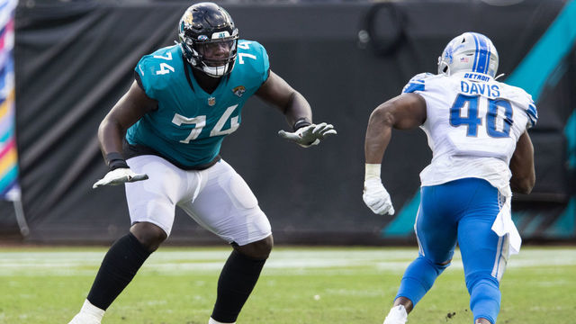 JACKSONVILLE, FLORIDA - OCTOBER 18: Cam Robinson #74 of the Jacksonville Jaguars blocks against Jarrad Davis #40 of the Detroit Lions during the second half of a game at TIAA Bank Field on October 18, 2020 in Jacksonville, Florida.
