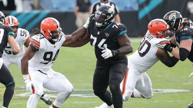 JACKSONVILLE, FL - NOVEMBER 29: Cleveland Browns Defensive End Adrian Clayborn (94) and Jacksonville Jaguars Offensive Tackle Cam Robinson (74) battle during the game between the Cleveland Browns and the Jacksonville Jaguars on November 29, 2020 at TIAA Bank Field in Jacksonville, Fl.