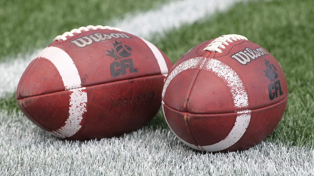 HAMILTON, ON - OCTOBER 4: A general view of CFL footballs lying on the field prior to play between the BC Lions and the Hamilton Tiger-cats in a CFL football game at Tim Hortons Field on October 4, 2014 in Hamilton, Ontario, Canada. The Tiger-cats defeated the Lions 19-17.