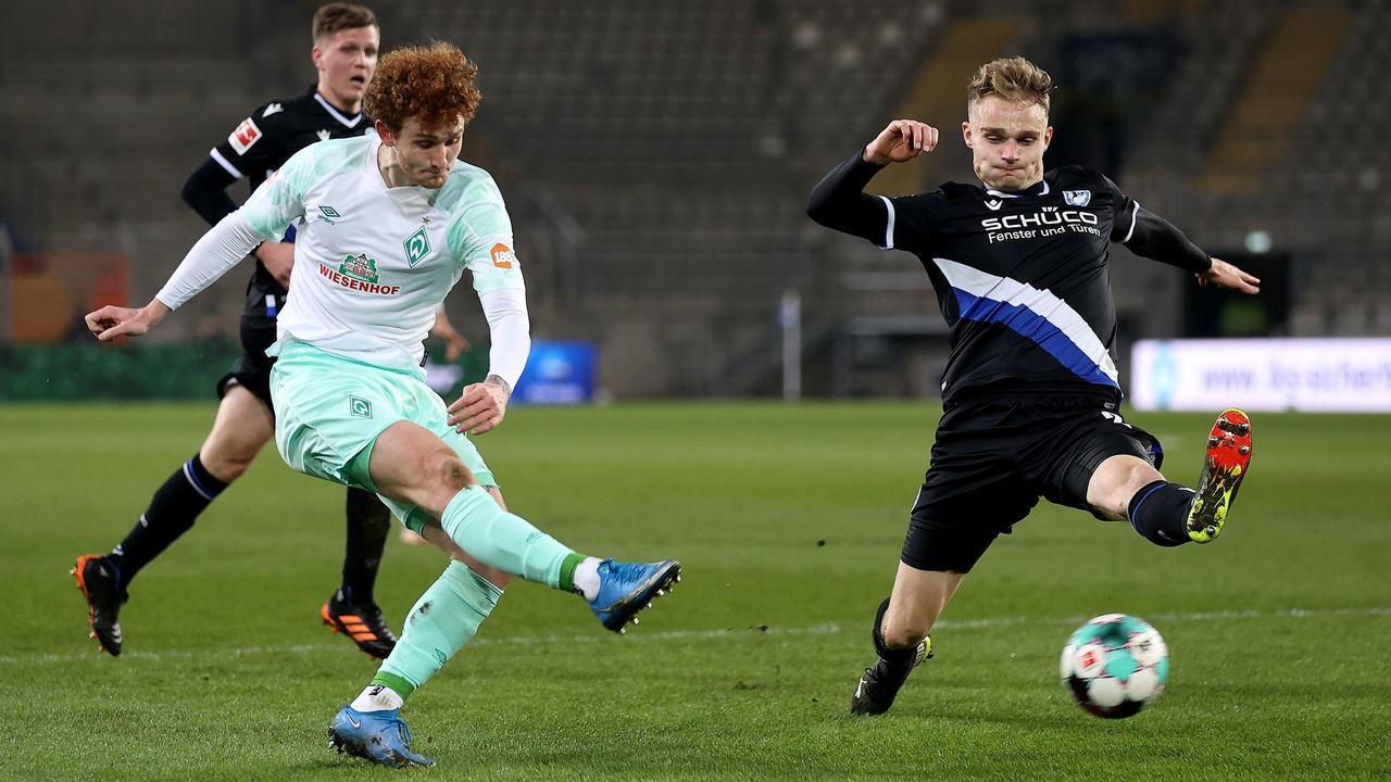 BIELEFELD, GERMANY - MARCH 10: Josh Sargent of Bremen takes a shot at goal during the Bundesliga match between DSC Arminia Bielefeld and SV Werder Bremen at Schueco Arena on March 10, 2021 in Bielefeld, which was postponed due to heavy weather from February 2, at Schueco Arena on March 10, 2021 in Bielefeld, Germany. Sporting stadiums around Germany remain under strict restrictions due to the Coronavirus Pandemic as Government social distancing laws prohibit fans inside venues resulting in games being played behind closed doors.