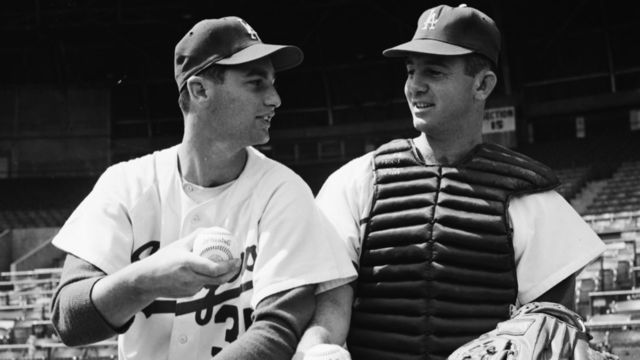 Baseball -- Dodgers, 17 March 1958. George Anderson;Ron Negray;Jim Gentile;Larry Sherry;Norm Sherry. 'Sports'. (Sleeve reads: SP-12288).;Caption slip reads: 'International News Photos. 235 East 45th Street, N.Y City. Photographer: H. Scharfman. Date: 1958-03-17. Assignment: Dodgers. Shows George Anderson, who got word his wife had baby, gets lit up from L to R, Ron Negray & Jim Gentile. Shows the Sherry brothers, pitcher Larry & catcher Norm'..