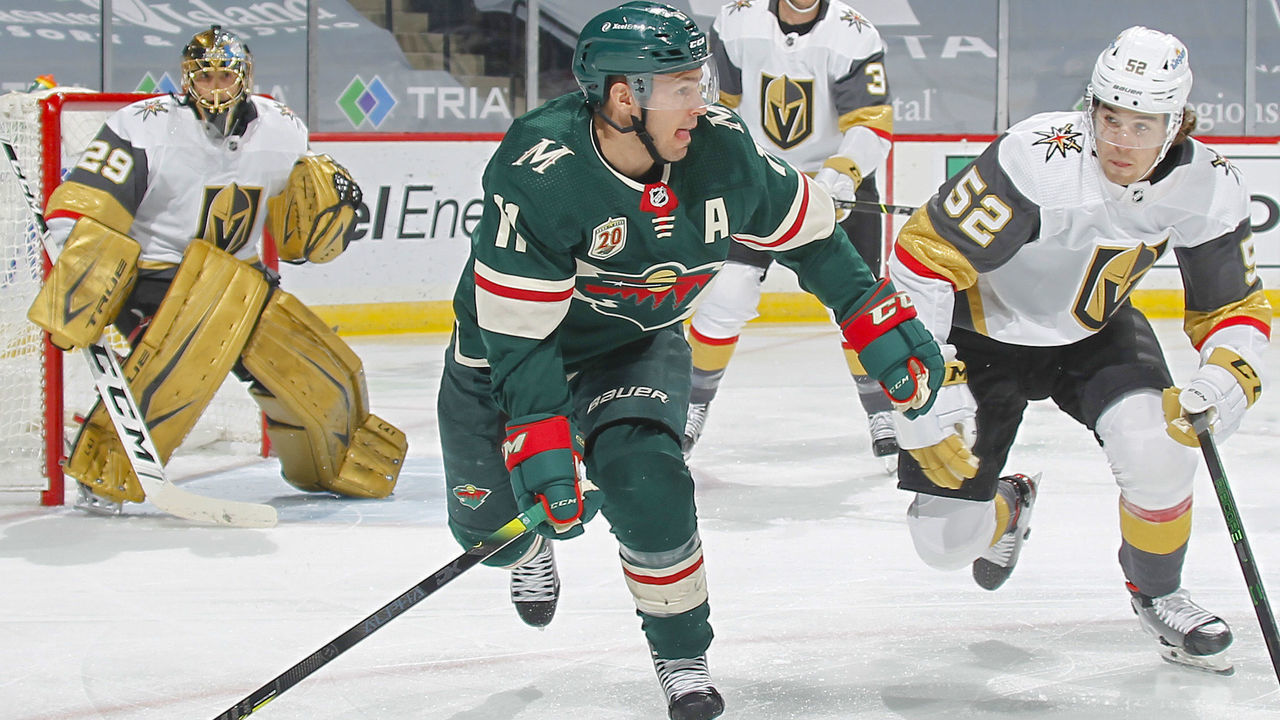 SAINT PAUL, MN - MARCH 10: Zach Parise #11 of the Minnesota Wild and Dylan Coghlan #52 of the Vegas Golden Knights skate to the puck during the game at the Xcel Energy Center on March 10, 2021 in Saint Paul, Minnesota.