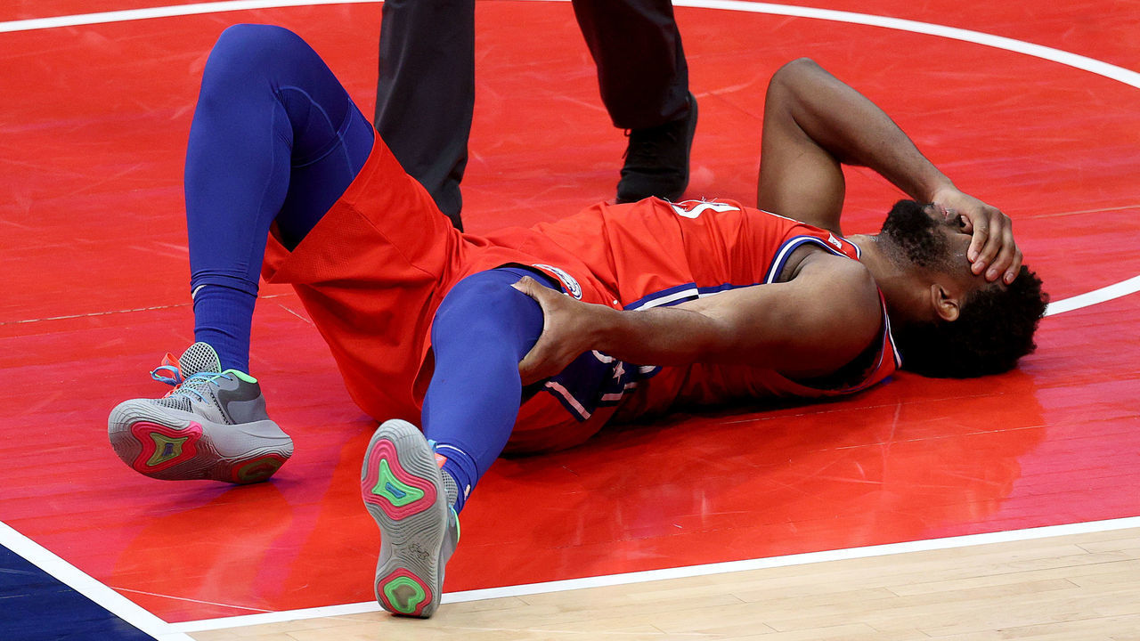 WASHINGTON, DC - MARCH 12: Joel Embiid #21 of the Philadelphia 76ers reacts after getting injured in the second half against the Washington Wizards at Capital One Arena on March 12, 2021 in Washington, DC. DC.