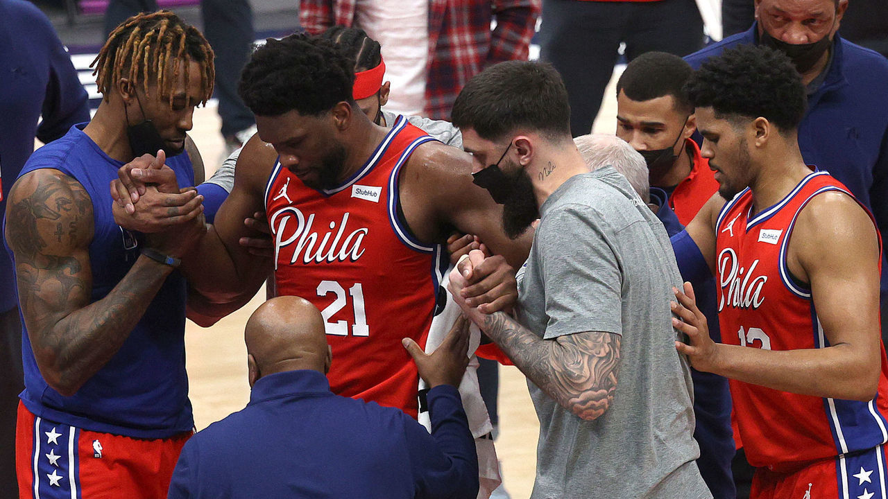 WASHINGTON, DC - MARCH 12: Joel Embiid #21 of the Philadelphia 76ers is helped up after getting injured in the second half against the Washington Wizards at Capital One Arena on March 12, 2021 in Washington, DC. DC.