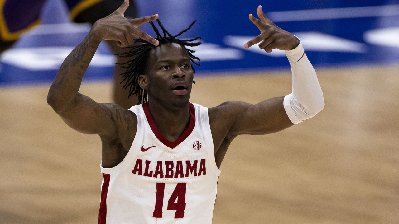NASHVILLE, TN - MARCH 14: Keon Ellis #14 of the Alabama Crimson Tide celebrates a 3-pointer against the LSU Tigers during the first half of their championship game in the SEC Men's Basketball Tournament at Bridgestone Arena on March 14, 2021 in Nashville, Tennessee.